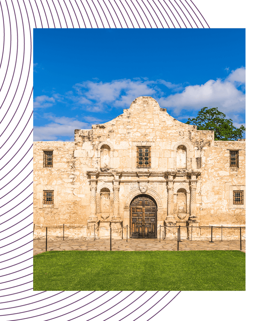 View of the historic Alamo Mission in San Antonio, Texas, showing its detailed facade and entrance on a sunny day.