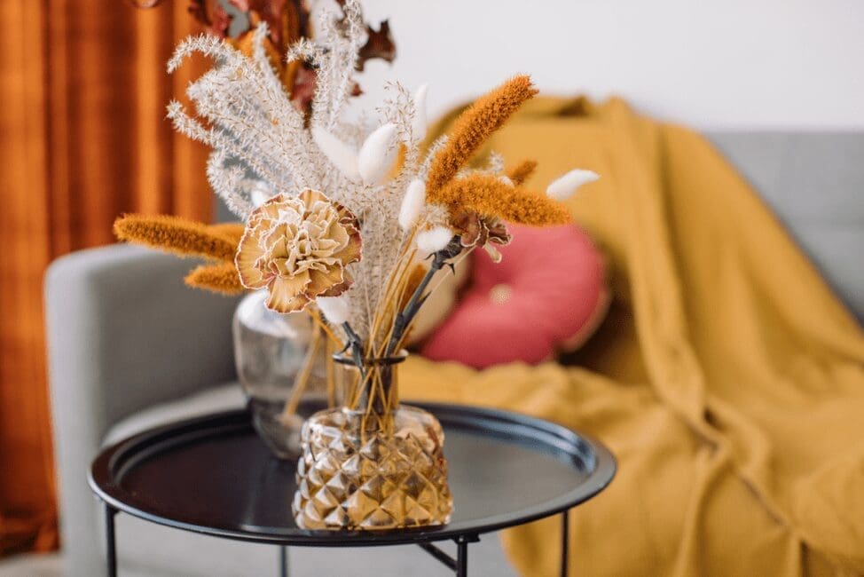 A tastefully arranged bouquet of dried flowers in a decorative vase on a coffee table, showcasing interior decor at City Base Vista in San Antonio, Texas.